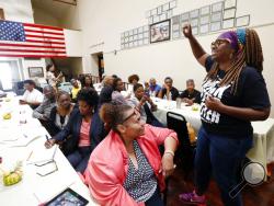 In this Aug. 24, 2018 photograph, LaTosha Brown, right, co-founder of Black Voters Matter, breaks out with an organizing song at a meeting of several Mississippi grassroots organizations at MACE, Mississippi Action for Community Education, headquarters in Greenville, Miss. Brown said the time is now for black women to lead again. She pointed to incidents like the attempt to close a majority of polling places in Randolph County, Ga., in August, as proof of the need for the kind of continued vigilance black w