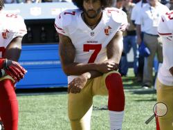 FILE - In this Sept. 25, 2016, file photo, San Francisco 49ers' Colin Kaepernick kneels during the national anthem before an NFL football game against the Seattle Seahawks, in Seattle. Kaepernick has a new deal with Nike, even though the NFL does not want him. Kaepernick’s attorney, Mark Geragos, made the announcement on Twitter, calling the former 49ers quarterback an “All American Icon” and crediting attorney Ben Meiselas for getting the deal done. (AP Photo/Ted S. Warren, File)