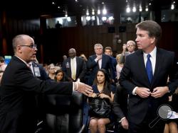 Fred Guttenberg, the father of Jamie Guttenberg who was killed in the Stoneman Douglas High School shooting in Parkland, Fla., left, attempts to shake hands with President Donald Trump's Supreme Court nominee, Brett Kavanaugh, right, as he leaves for a lunch break while appearing before the Senate Judiciary Committee on Capitol Hill in Washington, Tuesday, Sept. 4, 2018, to begin his confirmation to replace retired Justice Anthony Kennedy. Kavanaugh did not shake his hand. (AP Photo/Andrew Harnik)