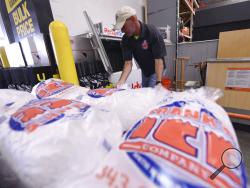 Mike Herring with Frank's Ice Company unloads another pallet of ice as people buy supplies at The Home Depot on Monday, Sept. 10, 2018, in Wilmington, N.C. Hurricane Florence rapidly strengthened into a potentially catastrophic hurricane on Monday as it closed in on North and South Carolina, carrying winds and water that could wreak havoc over a wide stretch of the eastern United States later this week. (Ken Blevins/The Star-News via AP)
