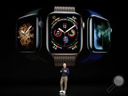 Apple CEO Tim Cook discusses the new Apple Watch 4 at the Steve Jobs Theater during an event to announce new products Wednesday, Sept. 12, 2018, in Cupertino, Calif. (AP Photo/Marcio Jose Sanchez)