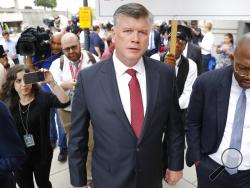 Members of the media follow attorney Kevin Downing, center, with the defense team for Paul Manafort, leaving federal court in Washington, Friday, Sept. 14, 2018. Former Trump campaign chairman Paul Manafort has pleaded guilty to two federal charges as part of a cooperation deal with prosecutors. The deal requires him to cooperate "fully and truthfully" with special counsel Robert Mueller's Russia investigation. The charges against Manafort are related to his Ukrainian consulting work, not Russian interferen