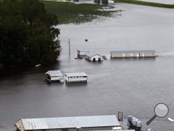 A hog farm is inundated with floodwaters from Hurricane Florence near Trenton, N.C., Sunday, Sept. 16, 2018. (AP Photo/Steve Helber)
