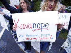 Protestors demonstrate outside a political event hosting U.S. Sen. Jeff Flake, R-Arizona, in Manchester, N.H., Monday, Oct. 1, 2018. Flake, days after a critical vote in support of Supreme Court nominee Brett Kavanaugh, made his second visit this year to New Hampshire. The visit will once again stoke suggestions that he might run against President Trump in 2020. (AP Photo/Charles Krupa)