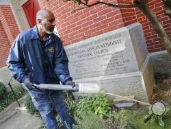 Pest Control Officer Gregory Cornes, from the D.C. Department of Health's Rodent Control Division, uses a duster to pump poison into rat burrows, found on the grounds of Metropolitan African Methodist Episcopal Church in downtown Washington, Wednesday, Oct. 17, 2019. Cornes will pump poison into the burrows and this powder will stick to the paws and fur, when the rats groom themselves, they unwittingly ingest it and die. The nation’s capital is facing a spiraling rat infestation, fueled by mild winters and 