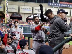 Boston Red Sox's Rafael Devers celebrates in the dugout after his three-run home run against the Houston Astros during the sixth inning in Game 5 of a baseball American League Championship Series on Thursday, Oct. 18, 2018, in Houston. (AP Photo/David J. Phillip)