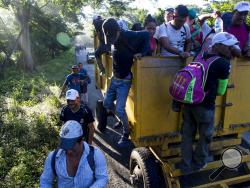 Central American migrants traveling with a caravan to the U.S. make their way to Pijijiapan, Mexico, Thursday, Oct. 25, 2018. The sprawling caravan of migrants hoping to make their way to the United States set off again, forming a column more than a mile long as the group trekked out of the town of Mapastepec in southern Mexico before dawn. (AP Photo/Rodrigo Abd)