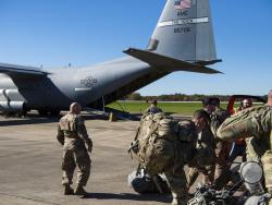 This Oct. 29, 2018 photo provided by the U.S. Air Force shows deployers from Headquarters Company, 89th Military Police Brigade, Task Force Griffin, ready to board a C-130J Super Hercules from Little Rock, Arkansas, at Fort Knox, Kentucky, in support of Operation Faithful Patriot. The Trump administration on Monday, Oct. 29, 2018, announced plans to deploy 5,200 active duty troops, double the 2,000 who are in Syria fighting the Islamic State group, to the border to help stave off the caravans. The main c