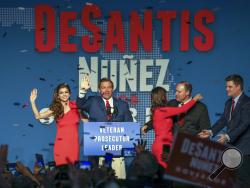 Republican Florida Governor-elect Ron DeSantis, center, waves to the supporters with his wife, Casey, left, and Republican Lt. Governor-elect Jeanette Nunez, third right, after thanking the crowd Tuesday, Nov. 6, 2018, in Orlando, Fla. DeSantis defeated Democratic candidate Andrew Gillum. (Chris Urso/Tampa Bay Times via AP)