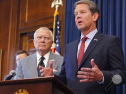 Republican Brian Kemp, right, speaks during a news conference as Georgia Gov. Nathan Deal listens in the Governor's ceremonial office at the Capitol on Thursday, Nov. 8, 2018, in Atlanta, Ga. Kemp resigned Thursday as Georgia's secretary of state, a day after his campaign said he's captured enough votes to become governor despite his rival's refusal to concede. (Bob Andres/Atlanta Journal-Constitution via AP)