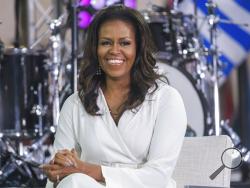 FILE - In this Oct. 11, 2018, file photo, Michelle Obama participates in the International Day of the Girl on NBC's "Today" show in New York. Michelle Obama blasts President Donald Trump in her new book, recalling how she reacted in shock the night she learned he would replace her husband in the Oval Office and tried to “block it all out.” In her book “Becoming,” set to come out on Tuesday, Nov. 13, she denounces the president for bragging to a TV host in 2005 about sexually assaulting women. (Photo by Char