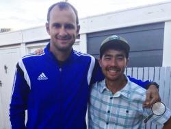 In this October 2018 photo, American adventurer John Allen Chau, right, stands for a photograph with Founder of Ubuntu Football Academy Casey Prince, 39, in Cape Town, South Africa, days before he left for in a remote Indian island of North Sentinel Island, where he was killed. Chau, who kayaked to the remote island populated by a tribe known for shooting at outsiders with bows and arrows, has been killed, police said Wednesday, Nov. 21. Officials said they were working with anthropologists to recover the b