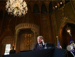 President Donald Trump talks with troops via teleconference from his Mar-a-Lago estate in Palm Beach, Fla., Thursday, Nov. 22, 2018. (AP Photo/Susan Walsh)