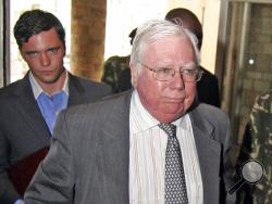 FILE - In this Oct. 7, 2008, file photo, Jerome Corsi, right, arrives at the immigration department in Nairobi, Kenya. Corsi, a conservative writer and associate of President Donald Trump confidant Roger Stone says he is in plea talks with special counsel Robert Mueller’s team. Jerome Corsi told The Associated Press on Friday, Nov. 23, 2018, that he has been negotiating a potential plea but declined to comment further. (AP Photo)