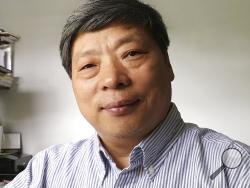 In this photo taken on July 2018 and released by Xu Xiaoli on Wednesday, Nov. 28, 2018, Lu Guang poses for a photo in New York. The wife of award-winning Chinese photographer Lu says he was taken away by state security agents more than three weeks ago during a trip to the country's far west. Lu's wife, Xu, says he was traveling in Xinjiang when she lost contact with him. (Xu Xiaoli via AP)