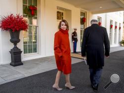 House Minority Leader Nancy Pelosi of Calif., left, speaks to a reporter as she and Senate Minority Leader Sen. Chuck Schumer of N.Y., right, walk back into the West Wing after speaking to members of the media outside of the White House in Washington, Tuesday, Dec. 11, 2018, following a meeting with President Donald Trump. (AP Photo/Andrew Harnik)
