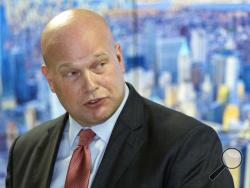 In this Nov. 21, 2018 photo, Acting Attorney General Matthew Whitaker, framed by a photograph of lower Manhattan, addresses law enforcement officials at the Joint Terrorism Task Force in New York. Whitaker has been advised by ethics officials that he does not need to recuse himself from overseeing the special counsel’s Russia probe. That’s according to a person familiar with the matter who spoke to The Associated Press on Thursday on condition of anonymity. (AP Photo/Mary Altaffer)