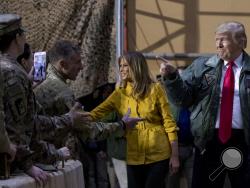 President Donald Trump and first lady Melania Trump greet members of the military at a hanger rally at Al Asad Air Base, Iraq, Wednesday, Dec. 26, 2018. (AP Photo/Andrew Harnik)