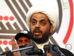 FILE - In this Jan. 6, 2016 file photo, Qais Khazali, the head of the Iran-backed Asaib Ahl al-Haq, speaks to his followers during a rally in Basra, Iraq. On Thursday, Dec. 27, 2018, Iraqi lawmakers are seizing on President Donald Trump's surprise visit to demand U.S. forces leave the country. Politicians from both sides of Iraq's political divide called on parliament to vote to expel U.S. troops. Khazali, the head of the militia that fought key battles against IS in north Iraq, promised on Twitter that Par