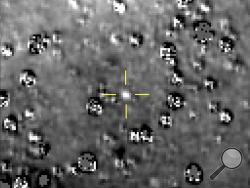 FILE - This composite image made available by NASA shows the Kuiper Belt object nicknamed "Ultima Thule," indicated by the crosshairs at center, with stars surrounding it on Aug. 16, 2018, made by the New Horizons spacecraft. The brightness of the stars was subtracted from the final image using a separate photo from September 2017, before the object itself could be detected. (NASA/Johns Hopkins University Applied Physics Laboratory/Southwest Research Institute via AP)