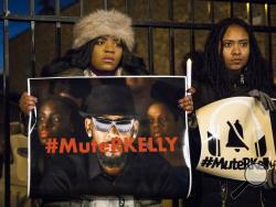 #MuteRKelly supporters protest outside R. Kelly's studio, Wednesday, Jan. 9, 2019 in Chicago. Lifetime's "Surviving R. Kelly" series which aired earlier this month, looks at the singer's history and allegations that he has sexually abused women and girls. Kelly, who turned 52 on Tuesday, has denied wrongdoing. (Ashlee Rezin/Chicago Sun-Times via AP)