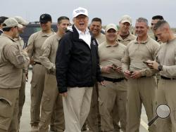 President Donald Trump turns as he talks to U.S. Customs and Border Protection officers at McAllen International Airport as he prepares to leave after a visit to the southern border, Thursday, Jan. 10, 2019, in McAllen, Texas. (AP Photo/ Evan Vucci)