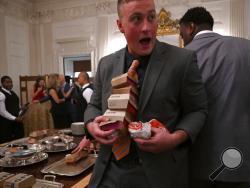 Guests attending a reception for the Clemson Tigers grab fast food sandwiches in the State Dining Room of the White House in Washington, Monday, Jan. 14, 2019. (AP Photo/Susan Walsh)