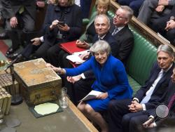 Britain's Prime Minister Theresa May reacts after she won a no-confidence vote against her government, in the House of Commons, London, Wednesday Jan. 16, 2019. Prime Minister Theresa May won the no confidence vote called for by opposition Labour Party leader Jeremy Corbyn, following the dramatic failure of the government Brexit vote. (Jessica Taylor, UK Parliament via AP)