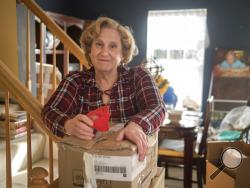 Mary Radnofsky, diagnosed with a rare form of leukoencephalopathy and in the early stages of dementia, prepares for her move to a new home that will be more suitable for her declining health, on Friday, Jan. 18, 2019, in Alexandria, Va. Faced with an aging American workforce, U.S. companies are increasingly navigating delicate conversations with employees suffering from cognitive declines or dementia diagnoses, experts say. (AP Photo/Kevin Wolf)