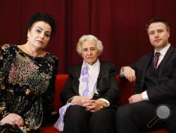 Holocaust survivor Anita Lasker-Wallfisch, center, her daughter Maya Jacobs Lasker-Wallfisch, left, and her grandson Simon Wallfisch, right, the son of Maya Jacobs Lasker-Wallfisch, pose for a photo after an interview with the Associated Press in Berlin, Germany, Sunday, Jan. 27, 2019. Maya Jacobs Lasker-Wallfisch and Simon Wallfisch, are two of thousands of Jews in Britain have applied for restoration of German citizenship stripped from their ancestors by the Nazis during the Third Reich. (AP Photo/Markus 