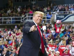 FILE - In this Nov. 26, 2018, file photo, President Donald Trump points to a supporter as he departs a rally at the Mississippi Coast Coliseum in Biloxi, Miss. President Donald Trump’s campaign has launched a state-by-state effort to prevent an intraparty fight that could spill over into the general-election campaign. The initiative includes changing state party rules, crowding out potential rivals and quelling any early signs of opposition. (AP Photo/Alex Brandon, File)