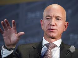 FILE- In this Sept. 13, 2018, file photo Jeff Bezos, Amazon founder and CEO, speaks at The Economic Club of Washington's Milestone Celebration in Washington. Bezos says the National Enquirer is threatening to publish nude photographs of him unless his private investigators back off the tabloid that detailed the billionaire’s extramarital affair (AP Photo/Cliff Owen, File)