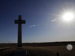 A cross, erected in memory of Fray Juan de Padilla, stands along US56 near Lyons, Kan., Tuesday, Feb. 12, 2019. The cross was a gift to the State of Kansas by the Knights of Columbus in 1950. (AP Photo/Orlin Wagner)