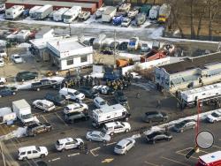 Law enforcement personnel gather near the scene of a shooting at an industrial park in Aurora, Ill., on Friday, Feb. 15, 2019. (Bev Horne/Daily Herald via AP)