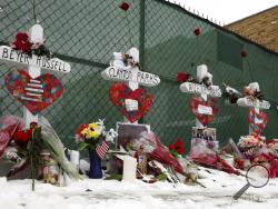 Crosses are placed for the victims of a mass shooting Sunday, Feb. 17, 2019, in Aurora, Ill., near Henry Pratt Co. manufacturing company where several were killed on Friday. Authorities say an initial background check five years ago failed to flag an out-of-state felony conviction that would have prevented a man from buying the gun he used in the mass shooting. (AP Photo/Nam Y. Huh)