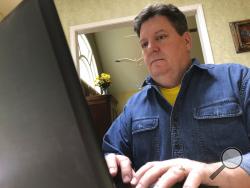 In this Friday, Feb. 15, 2019, photo Kevin McCreanor works on a laptop in Atlanta.(AP Photo/Cody Jackson)