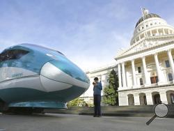 FILE - In this Feb. 26, 2015, file photo, a full-scale mock-up of a high-speed train is displayed at the Capitol in Sacramento, Calif. The Trump administration plans to cancel $929 million in U.S. money for California's beleaguered high-speed rail project and wants the state to return an additional $2.5 billion it's already spent. The U.S. Department of Transportation announcement Tuesday, Feb. 19, 2019, came after President Donald Trump last week threatened to make California pay back the money awarded to 