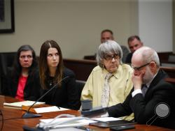 David Turpin, second from right, and wife, Louise, far left, listen to their charges as they are joined by their attorneys, Allison Lowe, second from left, and David Macher during a courtroom hearing, Friday, Feb. 22, 2019, in Riverside, Calif. The California couple who shackled some of their 13 children to beds and starved them pleaded guilty Friday to torture and other abuse in a case dubbed a "house of horrors." (AP Photo/Jae C. Hong, Pool)