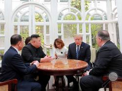 ALTERNATE CROP OF KNS802 - In this Thursday, Feb. 28, 2019, photo provided Friday, March 1, 2019, by the North Korean government, U.S. President Donald Trump, second from right, and North Korean leader Kim Jong Un, second from left, talk at a hotel in Hanoi, Vietnam. U.S. Sec. of State Mike Pompeo is at right. Kim Yong Chol, a North Korean senior ruling party official and former intelligence chief is at left. The content of this image is as provided and cannot be independently verified. (Korean Central News