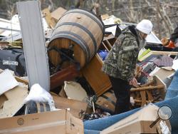 Julie Morrison looks through the debris of her destroyed home on Lee County Road 63 in Beauregard, Ala., Monday, March 4, 2019, the day after a deadly tornado ravaged the area, in Beauregard, Ala., Monday, March 4, 2019. (AP Photo/Julie Bennett)