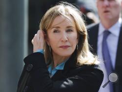 FILE - In this April 3, 2019 file photo, actress Felicity Huffman arrives at federal court in Boston to face charges in a nationwide college admissions bribery scandal. On Monday, May 13, 2019, Huffman is expected to plead guilty to charges that she took part in the cheating scam. (AP Photo/Charles Krupa, File)