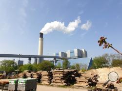 A chimney billows out steam at Berlin's Reuter West thermal power station on Wednesday, April 24, 2019. The energy company, together with a Swedish start-up, is testing the use of salt to store heat, which accounts for more than half the power consumed in Germany. (AP Photos/Frank Jordans)