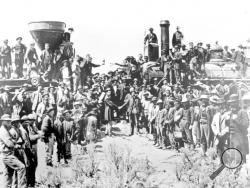 FILE - In this May 10, 1869, file photo, provided by the Union Pacific, railroad officials and employees celebrate the completion of the first railroad transcontinental link in Promontory, Utah. The completion of the Transcontinental Railroad was a pivotal moment in the United States, ushering in a period of progress and expansion nationwide. The Union Pacific's Locomotive No. 119, right, and Central Pacific's Jupiter edged forward over the golden spike that marked the joining of the nation by rail. (Andrew