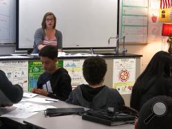 In this April 25, 2019, photo, science teacher Sarah Ott speaks to her class about climate literacy in Dalton, Ga. Teachers across the country describe struggles finding trustworthy materials to help them teach their students about climate change. (AP Photo/Sarah Blake Morgan)
