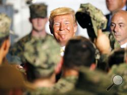 U.S. President Donald Trump greets to U.S. servicemen at U.S. Navy multipurpose amphibious assault ship USS Wasp at the U.S. Navy's Yokosuka base in Yokosuka, south of Tokyo Tuesday, May 28, 2019. (AP Photo/Eugene Hoshiko)
