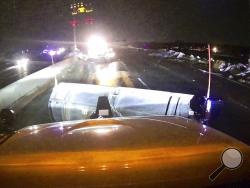 This image provided and posted by the Ohio Department of Transportation, early Tuesday, May 28, 2019, shows a view from one of the department's trucks as crews on Interstate 75 north of Dayton, Ohio, work to clean debris from the highway after a suspected tornado hit the area late Monday. (Ohio Department of Transportation via AP)