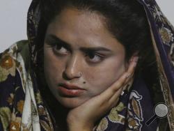 In this May 14, 2019, photo, Pakistani Christian Natasha Masih, speaks to the Associated Press in Faisalabad, Pakistan. Natasha begged her mother to bring her home from China, but it took an elaborate scheme devised by a small cabal of Christian men in her hometown of Faisalabad, in Pakistan's Punjab province, to orchestrate her escape from what began as an unhappy marriage, and ended in prostitution. (AP Photo/K.M. Chaudary)