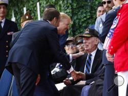 President Donald Trump and French President Emmanuel Macron greet veterans as they arrive to a ceremony to commemorate the 75th anniversary of D-Day at The Normandy American Cemetery, Thursday, June 6, 2019, in Colleville-sur-Mer, Normandy, France. (AP Photo/Alex Brandon)