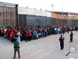 This May 29, 2019 file photo released by U.S. Customs and Border Protection (CBP) shows some of 1,036 migrants who crossed the U.S.-Mexico border in El Paso, Texas, the largest that the Border Patrol says it has ever encountered. The federal government is opening a new mass shelter for migrant children near the U.S-Mexico border and is considering housing children on three military bases to add 3,000 more beds to the overtaxed system in the coming weeks. (U.S. Customs and Border Protection via AP, File)