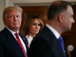 President Donald Trump and first lady Melania Trump attend a Polish-American reception with Polish President Andrzej Duda in the East Room of the White House, Wednesday June 12, 2019. (AP Photo/Jacquelyn Martin)